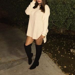 Sweater dress in tan with zippers.